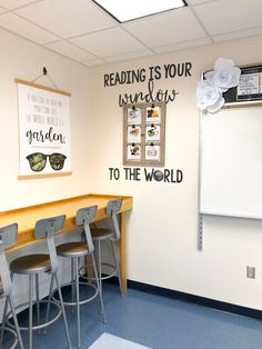 a classroom with chairs and a chalkboard on the wall that says reading is your window to the world