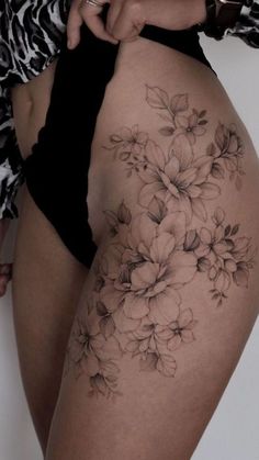 a woman's thigh with flowers on it