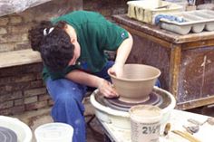 a man is working on a pottery wheel