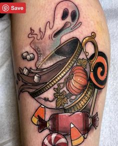 a tattoo on the leg of a person with candy and candies in front of them