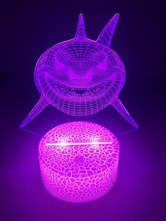 a purple lit up object sitting on top of a table