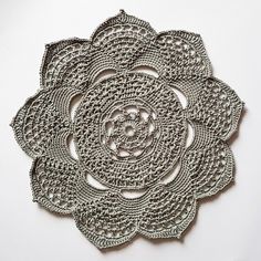 a crocheted doily is shown on a white surface