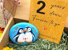 there is a penguin pin sitting in a box with two years down forever to go