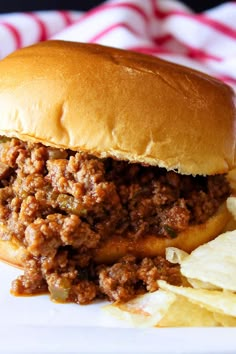 a sloppy joe sandwich with chips on the side