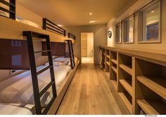 there are bunk beds in the room with no mattresses on each bed and shelves below