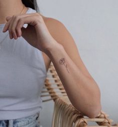 a woman with a small tattoo on her arm