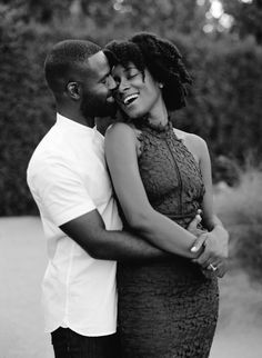 a black and white photo of a couple hugging