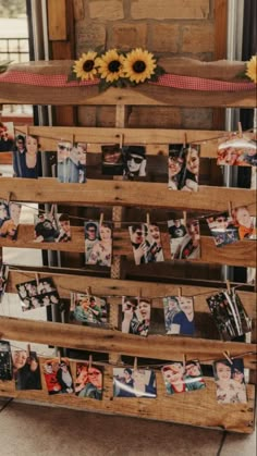 an old wooden pallet with pictures and sunflowers on the top is used as a display for family photos