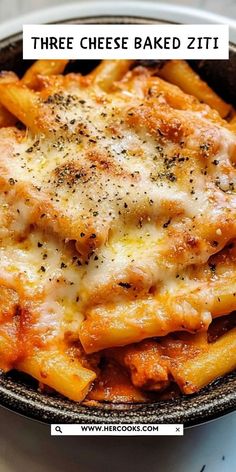 a bowl filled with cheesy pasta and cheese on top of a white table