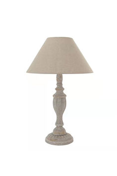 a white lamp with a beige shade on it