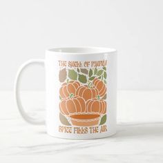 a coffee mug with an orange pumpkin on it