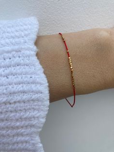 This delicate red string of fate bracelet is beautiful in its simplicity. D E T A I L S *It is made with the teeny tiniest gold vermeil Karen Hill tribe nuggets that come from Thailand. Beads measure around 1.3mm. They are handmade using traditional silversmith techniques passed down through generations. They have a 98% and above silver content and are plated in 24k gold that is 1 micron which is 40 times thicker than most gold plated jewellery. Over time  though you can expect  to see the silve Minimalist 14k Gold Red Bracelets, Minimalist Red 14k Gold Bracelets, Minimalist Red 14k Gold Bracelet, Red 14k Gold Dainty Bracelet, Dainty Red Beaded Bracelets For Everyday, Dainty Red Bracelet With Sliding Knot, Red Minimalist Beaded Bracelets For Everyday, Minimalist Red Beaded Bracelets For Everyday, Minimalist Red Beaded Bracelet With Tiny Beads