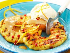 a blue plate topped with bananas and ice cream on top of a yellow table cloth