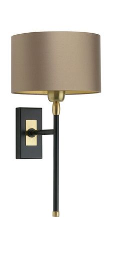 a wall light with a beige shade on the side and a black pole attached to it