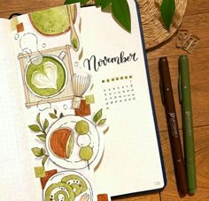 an open notebook on a wooden table next to a pen and some green items in it