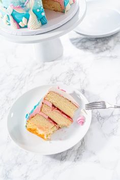 a piece of cake on a plate with a fork in front of it and the rest of the cake behind it