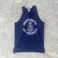 Vintage 1990s University of Toronto Tank Top  - Size L - Length 29" Chest 19.5" - Message for more information Please take note of the measurements listed as these are vintage clothes and may fit different than the tag size. Follow our page for more vintage clothing drops! DISCLAIMER: All items are vintage so please be mindful that if by chance there is a flaw on the item we simply may have just missed it. Inquire for more product information. Sleeveless Blue Tops For College, Collegiate Blue Sleeveless Tops, Blue Sleeveless Collegiate Tops, Blue Sleeveless Collegiate Style Top, Collegiate Cotton Tank Top For College, Blue Crew Neck Tank Top For Streetwear, Retro Blue Tops For School, Crew Neck Cotton Tank Top For College, 90s Style Cotton Tops For College