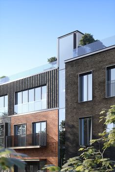 two brick buildings with balconies on the top and second story are facing each other