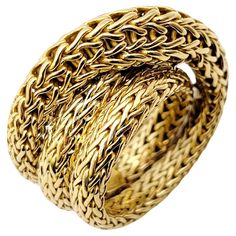 Ring size: 7 This wonderfully textured statement ring by John Hardy is an absolute stunner. Inspired by Bali and its time-honored jewelry-making traditions, John Hardy was founded in 1975 with a dedication to sustainable handcrafted jewelry. Substantial in both size and design, this unique designer piece will absolutely WOW. This incredible ring features the signature Hardy woven chain, wrapped up and twisted around in luxurious 18 karat yellow gold. This striking ring crosses over the finger an Designers Jewelry Collection, Woven Chain, John Hardy, Unique Designers, Ruby Ring, Ring Size 7, Cocktail Ring, Cocktail Rings, Statement Ring