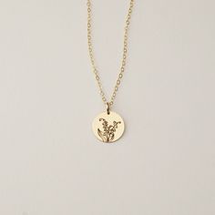 Celebrate your birth month with our Birth Flower Necklace. Delicately engraved with your birth month's patron flower, perfect for you, or as a gift for a loved one. Every piece is handcrafted with love in Charleston, SC, using 90% recycled and 100% ethically sourced raw materials from the USA-- a simple way to help make our planet a better place. Includes gift-ready packaging with a recycled cotton card printed with compostable inks, recycled tissue, and a linen drawstring back printed with compostable inks! MATERIALS: * GF = 14k Gold Fill * SS = Sterling Silver * RG = 14k Rose Gold Fill DETAILS: Disc available in 9mm, 13mm, and 16mm Includes a dainty matching flat cable chain. (As shown in the first three photos. Other Chains are also available for upgrades, please reach out for the price May Birth Flowers, Celestial Necklace, Moon Pendant Necklace, Zodiac Pendant, Flower Pendant Necklace, Gold Moon, Moon Pendant, Printed Bags, Birth Flowers