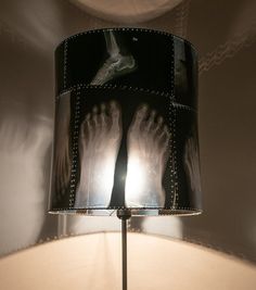 a lamp that is on top of a table with two hands and feet in it