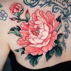 a woman's chest with pink flowers on it