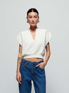 When casual meets chic, you get this sweatshirt top with a daring notch neckline, breezy cap sleeves, and a semi cropped silhouette. (This one comes in Porcelain.) Wear it with the Lincoln Pant. | Lenon Top in Porcelain | Ethical Essentials Chic Cropped Short Sleeve Top For Spring, Chic Slightly Cropped White Top, Chic Relaxed Fit Short Sleeve Top, Effortless White Top For Casual Gatherings, White V-neck Top For Casual Gatherings, Relaxed Fit V-neck Crop Top, Chic Cotton V-neck Top With Relaxed Fit, Chic Slightly Cropped Tops For Spring, Chic Slightly Cropped Top For Fall