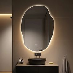 a bathroom with a sink, mirror and lights on the wall above it's counter