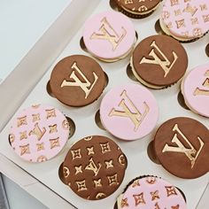 decorated cookies in the shape of louis vuitton's are displayed on a white box