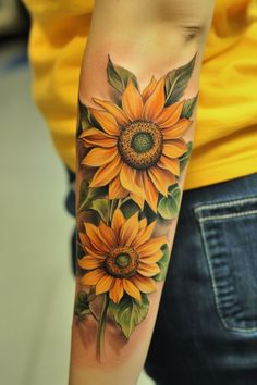 a woman with a sunflower tattoo on her arm