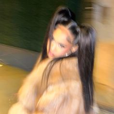 a woman with long hair walking down the street