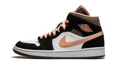 The Women’s Air Jordan 1 Mid “Peach Mocha” is a women’s edition of Michael Jordan’s first signature shoe in a spring and summer-ready colorway.  The alternate Jordan 1 Mid debuted in 2007 as part of the “New/Old Love” pack that paid homage to Michael’s love of basketball and his newfound appreciation for competitive motorsports.  In the years since, the Jordan 1 Mid has become one of the most popular and creative canvases for Jordan Brand, which is exemplified by this “Peach Mocha” design.  Black synthetic nubuck overlays on the forefoot, eyestay, collar, and heel contrast the upper’s white leather base while a Peach leather Swoosh can be found on either side of the shoe.  The same pinkish hue appears on the “Wings” branding on the collar and on the laces on top of the black nylon tongue. Mocha Shoes, Womens Air Jordan 1, Womens Air Jordan, Wmns Air Jordan 1, Vapour Max Nike, Jordan Ones, Jordan Model, Air Jordan 1 Mid Se, Awesome Shoes