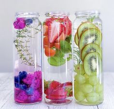 three glass jars filled with different types of fruits and veggies in each jar