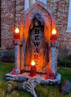 a grave with candles lit up in front of it