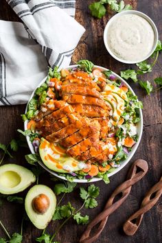 chicken salad with avocado and ranch dressing in a bowl on a wooden table