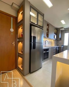 a modern kitchen with stainless steel appliances and cabinets