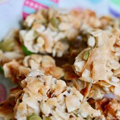 some kind of granola with nuts and seeds in it on a tablecloth covered plate