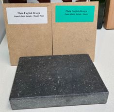 two black granite blocks sitting next to each other on top of a white countertop