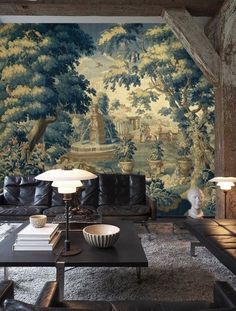 a living room filled with furniture and a mural on the wall