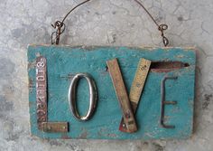 a blue sign that says love with some tools attached to it