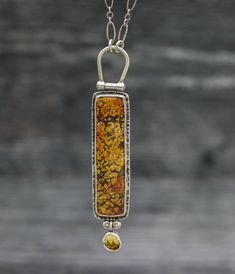 This necklace features a beautiful plume agate that has a mottled yet distinct pattern in warm earthy orange, peach and browns. It reminds me of autumn leaves and warm sunshine. The back is patterned with a complimentary pattern to the stone and it hangs from a hinged bail. Dangling below is a warm glowy drop of mandarine citrine. The piece is 1/2 inch wide and 3 inches long. ♦Chain: This comes on an oval link chain that is currently 18-20 inches. It has a lobster claw clasp and 2 inch extension Artisan Amber Cabochon Necklace, Amber Cabochon Artisan Necklace, Artisan Amber Jewelry With Natural Inclusions, Artisan Brown Necklace With Large Stone, Artisan Brown Jewelry With Natural Inclusions, Brown Pendant Jewelry With Natural Inclusions, Plume Agate, Citrine Pendant, Handmade Jewelry Necklace