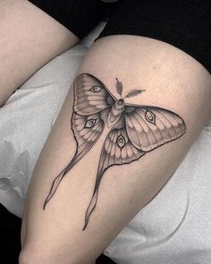 a small butterfly tattoo on the right thigh and lower leg, it is black and white