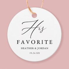 a white ceramic ornament with the words his favorite on it, hanging from a string