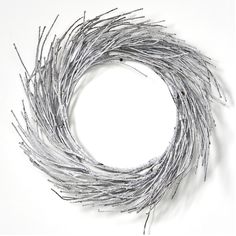 a wreath made out of twigs on a white background