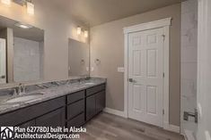 a large bathroom with double sinks and mirrors