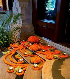 an arrangement of orange flowers on the steps