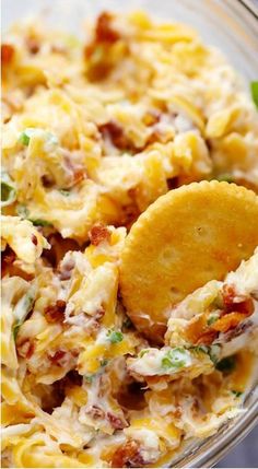 a glass bowl filled with pasta and tortilla chips