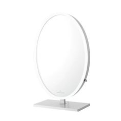 a round mirror sitting on top of a metal stand with a white surface underneath it