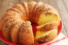 a bundt cake with slices cut out on a red plate