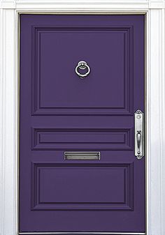 the front door is painted purple and has a metal handle on it's side